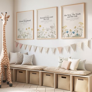 May include: Three framed prints with floral designs and inspirational quotes. The prints are hung on a white wall above a beige bench with cushions. The quotes are "I am the Good Shepherd", "I am the Resurrection and the Life", and "I am the Way, the Truth and the Life".