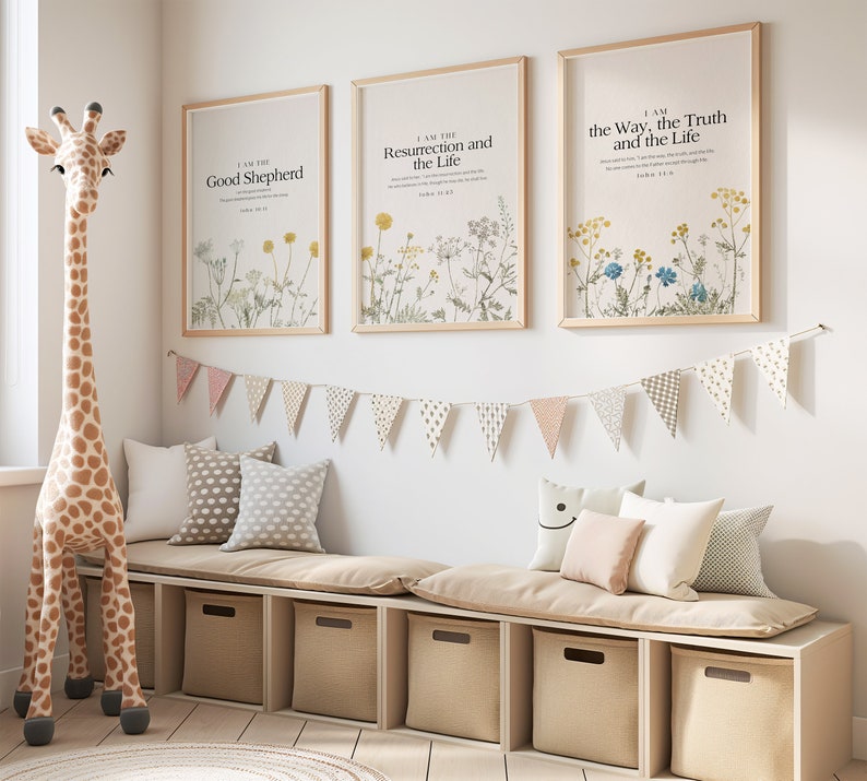 May include: Three framed prints with floral designs and inspirational quotes. The prints are hung on a white wall above a beige bench with cushions. The quotes are "I am the Good Shepherd", "I am the Resurrection and the Life", and "I am the Way, the Truth and the Life".