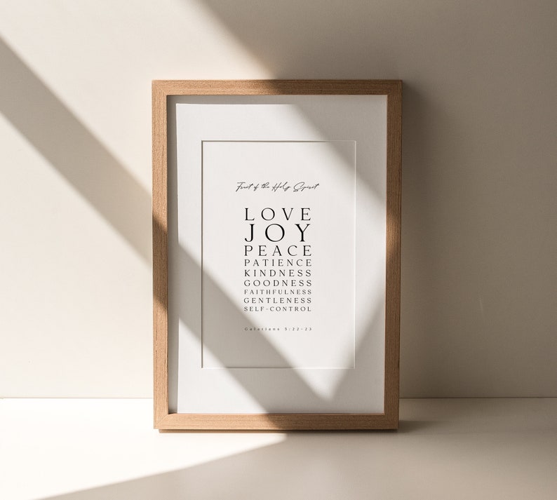 May include: A framed print with a white background and black text. The text reads "Fruit of the Holy Spirit" and lists the following words: Love, Joy, Peace, Patience, Kindness, Goodness, Faithfulness, Gentleness, Self-Control. The text is centered on the page and is in a simple, modern font.