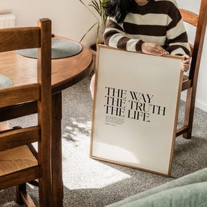 May include: A framed print with the text "THE WAY THE TRUTH THE LIFE." and the scripture reference "JOHN 14:6" in a minimalist black font on a white background.