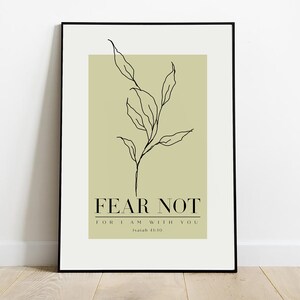 May include: A framed print with a minimalist line drawing of a leafy branch on a light green background. The text "FEAR NOT FOR I AM WITH YOU Isaiah 41:10" is printed below the branch.
