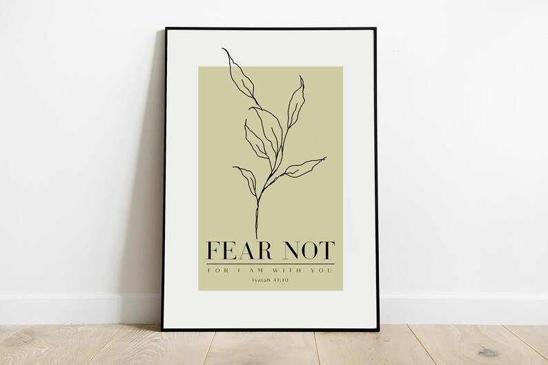 May include: A framed print with a minimalist line drawing of a leafy branch on a light green background. The text "FEAR NOT FOR I AM WITH YOU Isaiah 41:10" is printed below the branch.