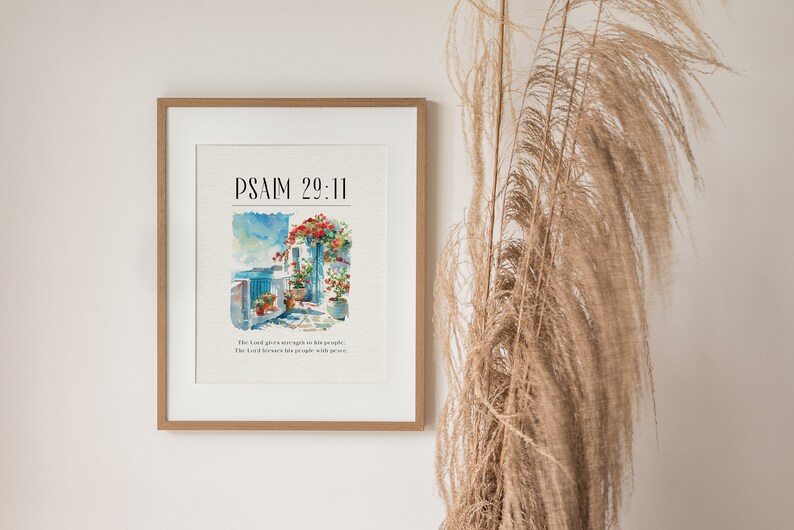 May include: A framed print with a watercolor painting of a building with flowers and the text "PSALM 29:11" and the text "The Lord gives strength to his people. The Lord blesses his people with peace."