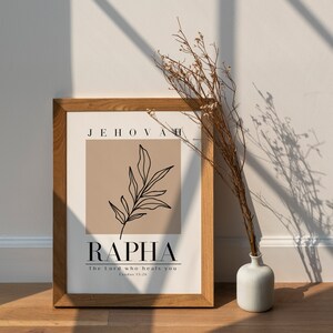 May include: A framed print with a beige background and a black line drawing of a leaf. The text "JEHOVAH RAPHA The Lord who heals you Exodus 15:26" is printed in black.