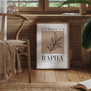 May include: A framed print with a brown background and a black line drawing of a branch with leaves. The text "JEHOVAH RAPHA The Lord who heals you Exodus 15:26" is printed in black.