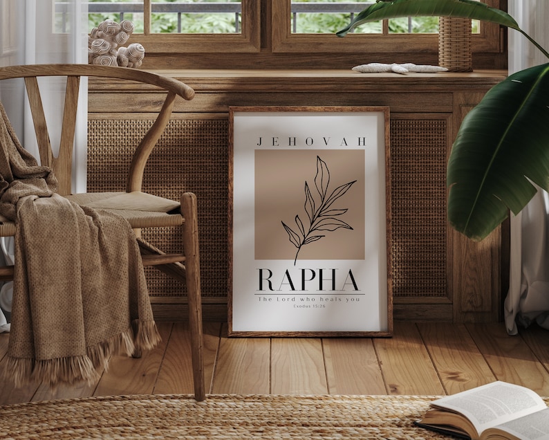 May include: A framed print with a brown background and a black line drawing of a branch with leaves. The text "JEHOVAH RAPHA The Lord who heals you Exodus 15:26" is printed in black.