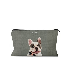 May include: A gray zippered pouch with a French Bulldog wearing a bow tie printed on the front. The text "NAMI" is printed above the dog.
