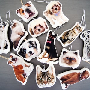 Peut inclure: Une collection de d&eacute;corations de No&euml;l sur le th&egrave;me des animaux de compagnie, repr&eacute;sentant diverses races de chiens et de chats. Chaque ornement est une forme douce et moelleuse avec une image d&eacute;taill&eacute;e d'un chien ou d'un chat, avec des boucles pour suspendre.