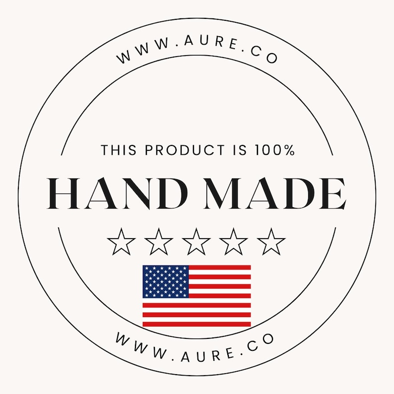 May include: A black and white circular stamp with the text "WWW.AURE.CO" at the top and bottom. The text "THIS PRODUCT IS 100% HAND MADE" is in the center of the stamp. Five white stars are below the text. An American flag is below the stars.