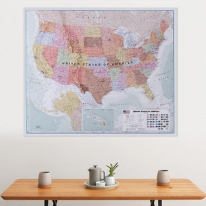 May include: A detailed map of the United States of America with state borders and major cities labeled. The map is printed on a white background with a blue border. The map includes a smaller inset map of Hawaii and Alaska. The map also includes a key with flags of the United States.