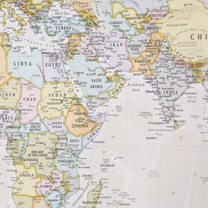 May include: A detailed map of the world with a focus on Asia, Africa, and the Middle East. The map is printed on a white background with colored borders for each country. The map includes country names, major cities, and geographic features.