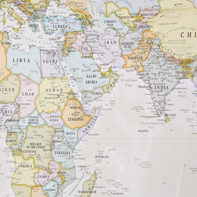 May include: A detailed map of the world with a focus on Asia, Africa, and the Middle East. The map is printed on a white background with colored borders for each country. The map includes country names, major cities, and geographic features.
