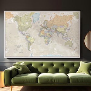 May include: A beige world map with political boundaries and country names printed on it. The map is framed and hanging on a dark gray wall above a green velvet sofa.