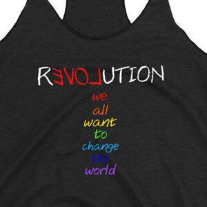 May include: A black tank top with the text "REVOLUTION" in red, "we" in orange, "all" in yellow, "want" in green, "to" in blue, "change" in indigo, and "the world" in violet.