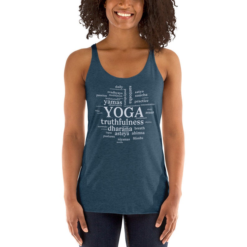 May include: A dark blue tank top with a white word cloud design that says "YOGA" in large letters and includes words like "truthfulness", "dharana", "breath", "tapas", "asteya", "ahimsa", "niyamas", and "slimbs".