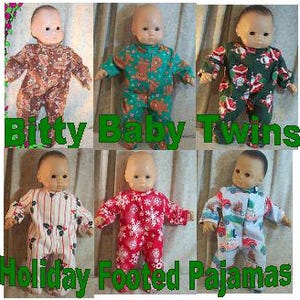 May include: Six Bitty Baby Twins dolls wearing holiday-themed footed pajamas. The pajamas feature various patterns, including floral, Christmas trees, and snowflakes. The text "Bitty Baby Twins" and "Holiday Footed Pajamas" are displayed.