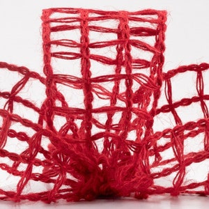 May include: Red burlap ribbon with a woven grid pattern. The ribbon is made of natural fibers and has a rustic look.