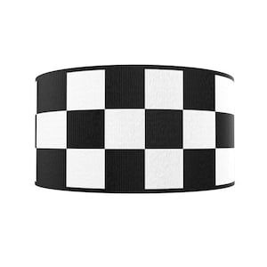 May include: Black and white checkered ribbon. The ribbon is made of a woven fabric with a slightly textured surface.