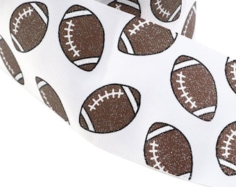 May include: White ribbon featuring a repeating pattern of brown American footballs. Each football has white laces and end stripes. The ribbon is suitable for crafting, gift wrapping, or sports-themed decorations.