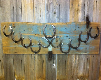 Coat & Hat rack attached to this vintage covered wagon feed lid.