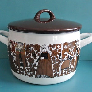 May include: White enamel pot with a brown lid and a brown and white design of people and flowers.