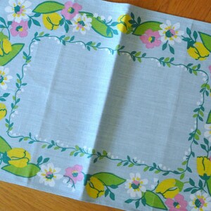 Swedish vintage 1960s printed rectangular linen M.Buhler design tablet tablecloth with conv. multicolor flower feame on light blue bottom