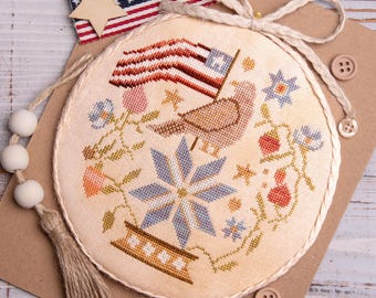 Schema per punto croce con uccello patriottico - ornamento primitivo americano America 250 (download PDF)