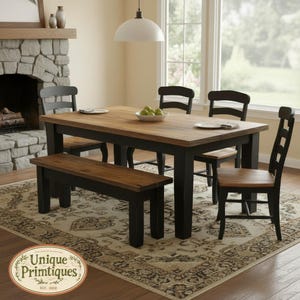 May include: A rectangular dining table with a natural wood top and black legs, accompanied by three black chairs with wood seats and one matching wooden bench. A white bowl containing green apples sits in the center of the table surface.