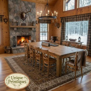 May include: A rustic dining room featuring a long wooden table surrounded by wooden chairs, set on a large patterned rug. A stone fireplace with a burning fire and a deer mount sits to the left, under a large iron chandelier with ten lights.