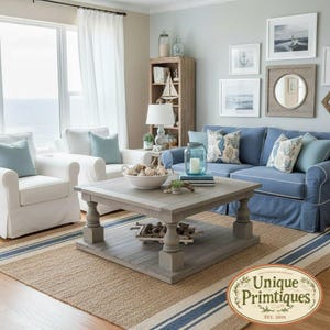 May include: A square wooden coffee table with a lower shelf, featuring a weathered gray finish and turned legs. The table is positioned in a living room with a blue sofa, white armchairs, and a striped rug. A logo reads Unique Primtiques Est. 2010.