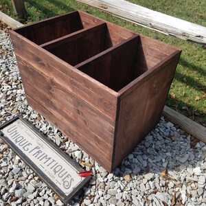 May include: A dark brown wooden storage box with three compartments. The box is made of reclaimed wood and has a rustic finish.