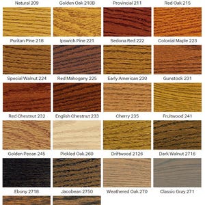 May include: A grid of twenty-six wood stain color samples, each displaying a unique wood grain texture and tone. Labels include Natural 209, Golden Oak 210B, Provincial 211, Red Oak 215, Puritan Pine 218, Ipswich Pine 221, Sedona Red 222, and Colonial Maple 223.