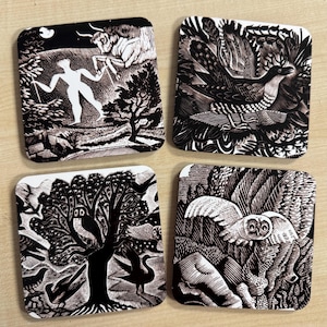 May include: Set of four square coasters with black and white linocut designs. Each coaster features a different nature-themed image, including a figure with a bull, a bird, owls in a tree, and an owl in flight.