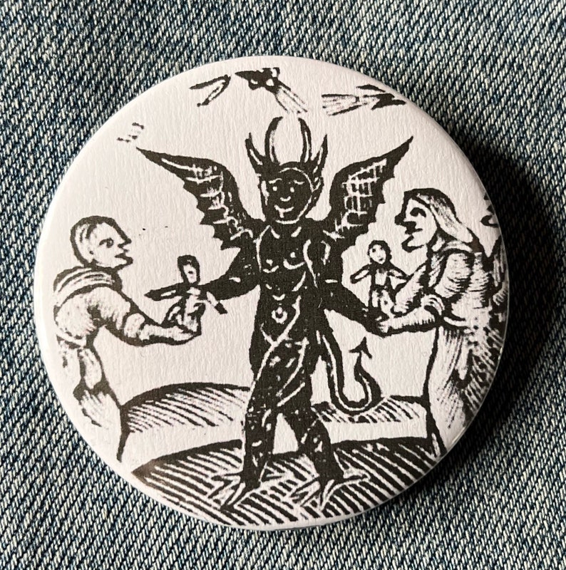 May include: A black and white illustration of a devil with wings and a tail, holding a doll. Two people are standing on either side of the devil, one holding a doll and the other holding a cross.