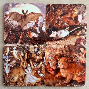 May include: A set of four square coasters with fantasy-themed artwork. Each coaster displays a different scene, including a bat, fairies, a mouse, a rabbit, and a kitten. The illustrations have a vintage, storybook aesthetic with muted colours.