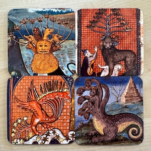 May include: Set of four square coasters featuring medieval illustrations of mythical creatures. The coasters showcase a variety of designs, including a multi-headed beast, a lion-like figure, and a phoenix. The color palette includes shades of orange, blue, and gold.