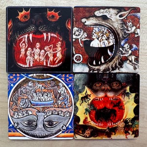 May include: Four square coasters featuring medieval-style illustrations of monstrous creatures with open mouths and people inside. The creatures are depicted in a dark, fiery setting.