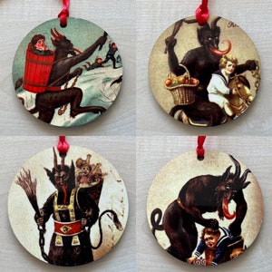 May include: Four round Christmas baubles featuring a red-suited devil figure with horns and a tail. Each bauble depicts a different scene with the devil interacting with children. The baubles are decorated with gold accents and have a red ribbon attached.
