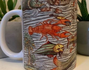 May include: White ceramic mug featuring a colourful illustration of sea creatures, including a lobster, a fish, and a seahorse. The illustration is in a vintage style and features intricate details.