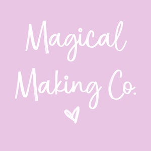 May include: White text on a light pink background reads "Magical Making Co." with a small heart symbol below the text.