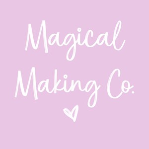 May include: A light purple background with the words "Magical Making Co." in white script. A small white heart is below the text. The text has a brush stroke effect.