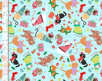 May include: A light blue fabric featuring a repeating pattern of cats wearing winter sweaters, scarves, and hats, interspersed with Christmas ornaments, candy canes, and gifts. A ruler along the left and bottom shows a scale of 11 inches.