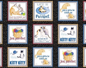 May include: A fabric panel featuring various cat-themed illustrations. Each square has a white background with a cat image and text like "Eat Sleep Play" or "Kitty Kitty." The background is black with a heart pattern, and the squares are framed in blue, red, and gray.