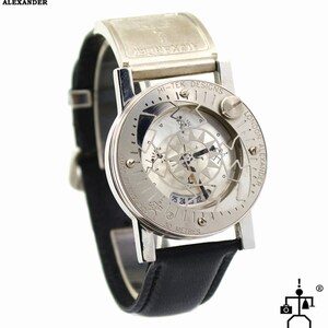 May include: A silver and black wristwatch with a skeletonized dial and a compass feature. The watch face has the text "HI-TEK DESIGNS LONDON ALEXANDER" and "MADE IN ENGLAND". The watch is water resistant to 30 meters.