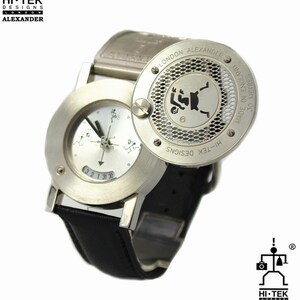 May include: A silver wristwatch with a black leather band. The watch face has a white background with black markings and a small compass. The watch has a round, silver case with a grid pattern and the text "HI-TEK DESIGNS LONDON ALEXANDER" on the back.