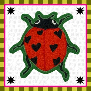 May include: An embroidered patch featuring a red ladybug with black heart-shaped spots on its wings. The ladybug has a black head, green legs, and a green outline. The background is white with the repeating text singing dog and four black stars.