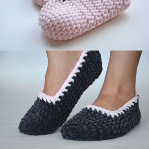 May include: A pair of pink and grey knitted slippers with a black trim. The slippers are soft and cosy, perfect for keeping your feet warm in the winter.