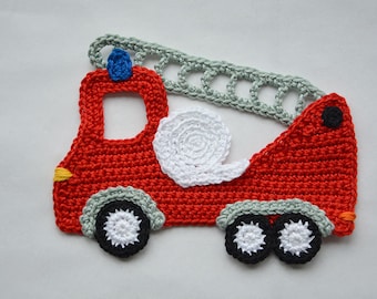May include: A red crocheted fire truck with a white crocheted hose and gray crocheted ladder. The truck has black wheels with white centers.