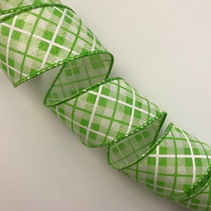 May include: Green and white checkered ribbon with a white background and green squares. The ribbon has a white edge.