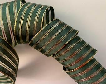 Peut inclure: Ruban vert foncé enroulé avec des rayures verticales dorées et argentées. Le ruban a un aspect texturé et est probablement utilisé à des fins décoratives, comme l'emballage de cadeaux ou l'artisanat. Le ruban mesure environ 5 cm de large.